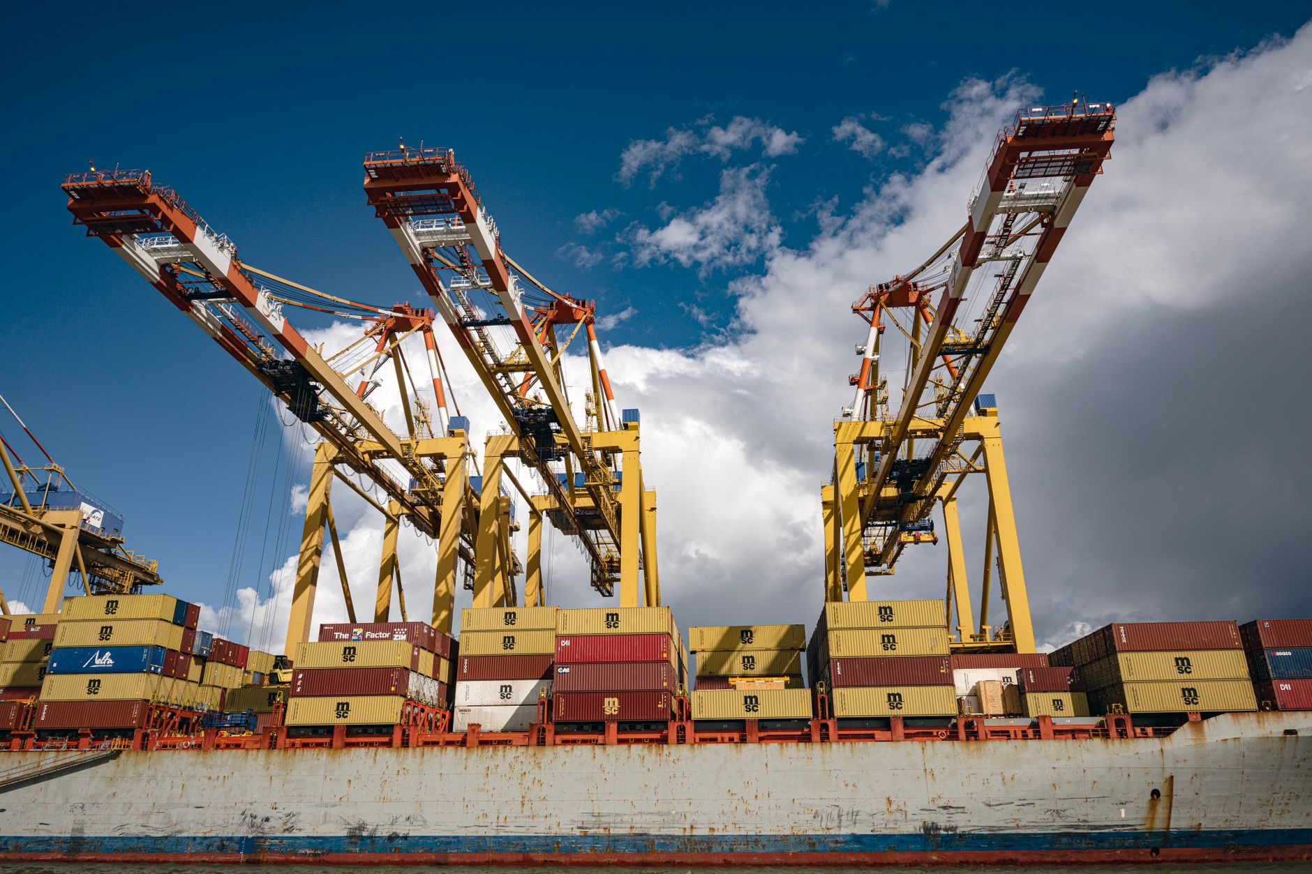 Gantry cranes unloading a container ship