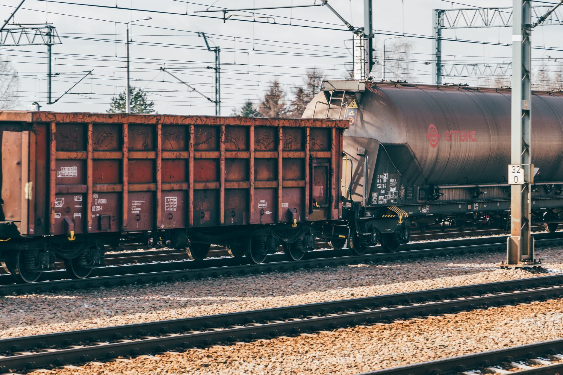 Freight train on a railway through mountainous terrain