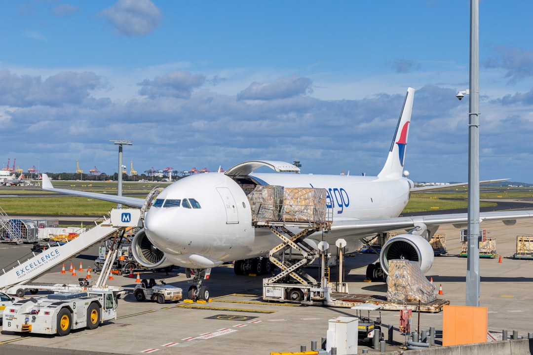 Large freighter aircraft being loaded with palletized air cargo