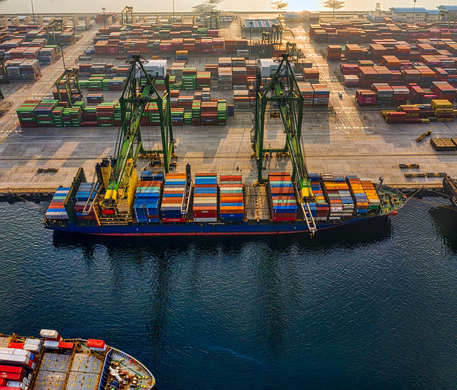 Container ship being worked by ship-to-shore cranes at a gateway port