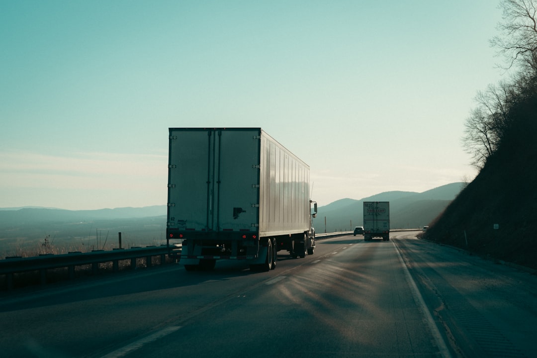 Fleet of long-haul freight trucks lined up at a distribution terminal