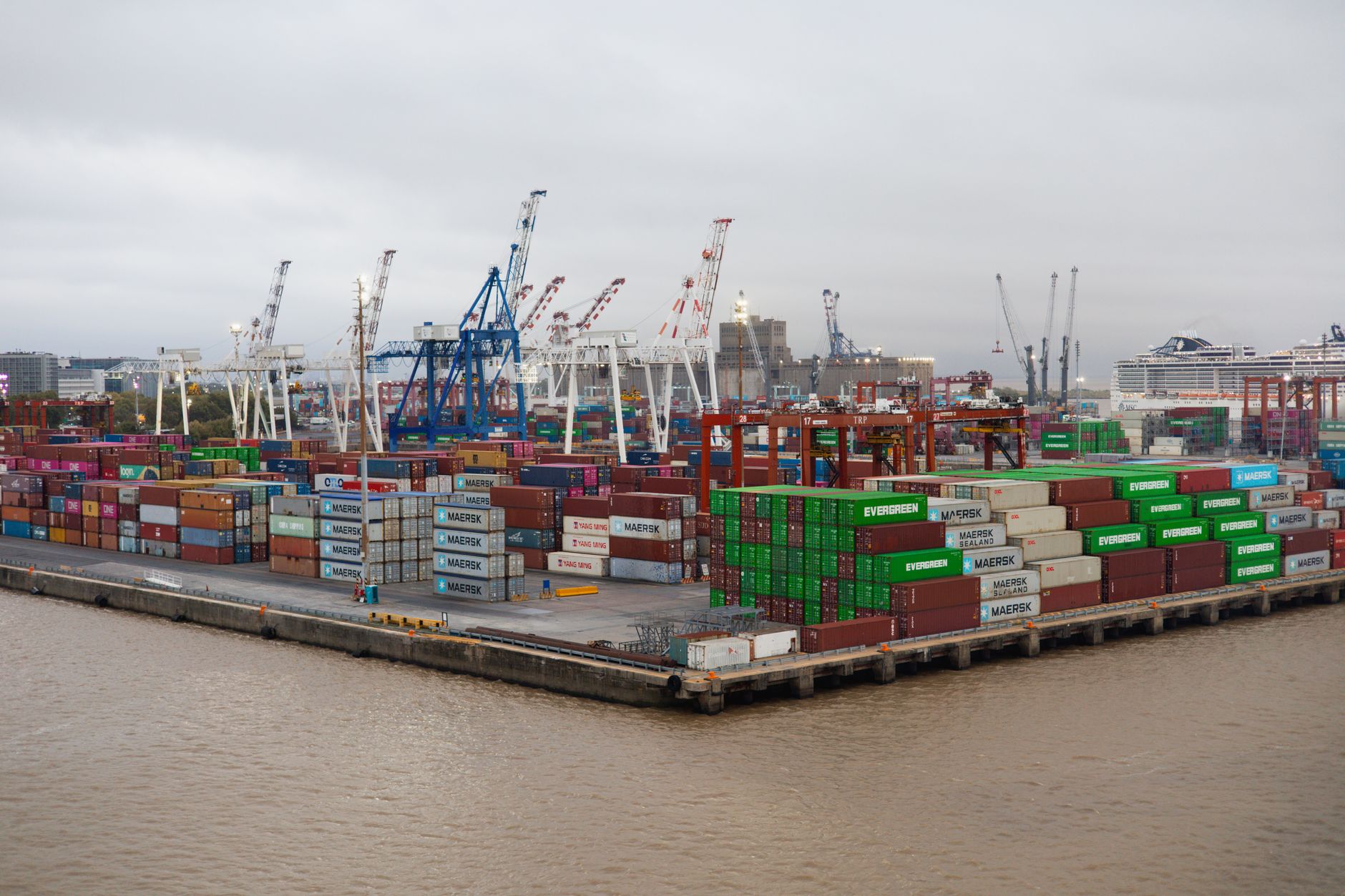 Stacks of shipping containers and gantry cranes at a South American container terminal