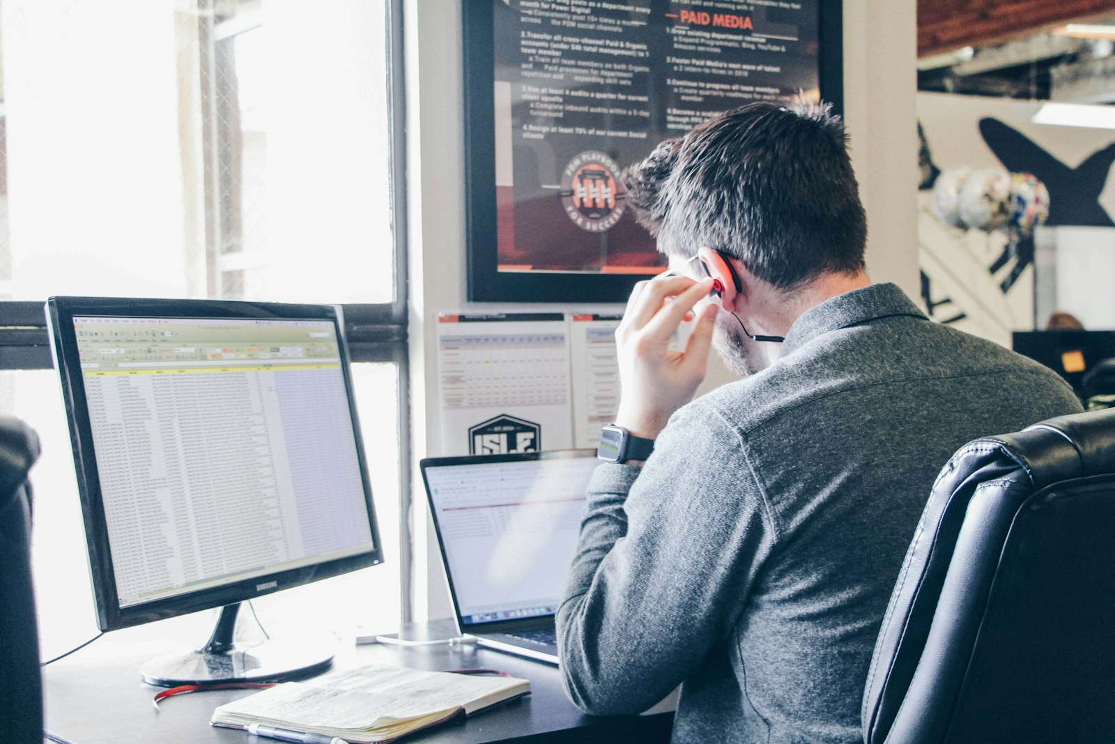 Truck dispatcher reviewing freight broker rate documents on a laptop
