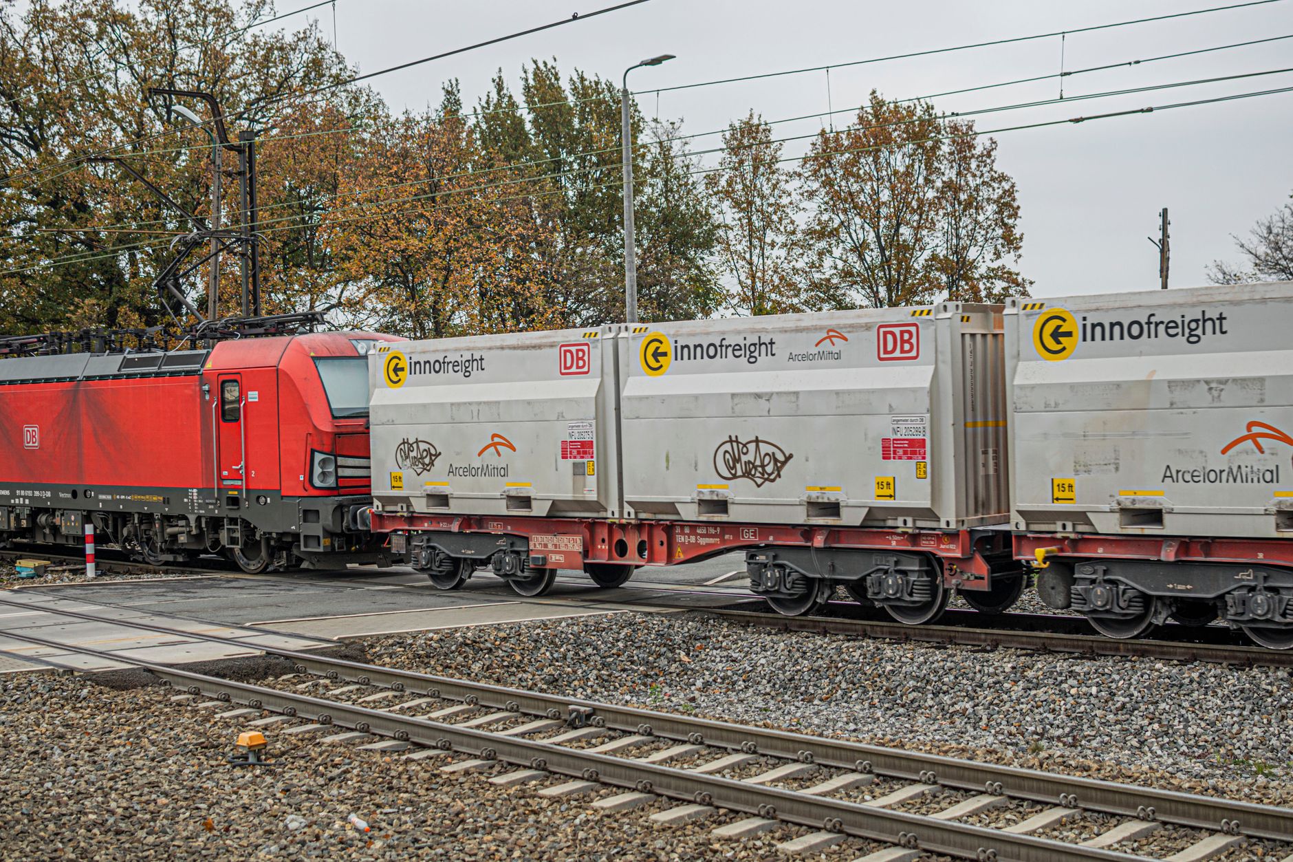 Freight train carrying shipping containers on a rail line