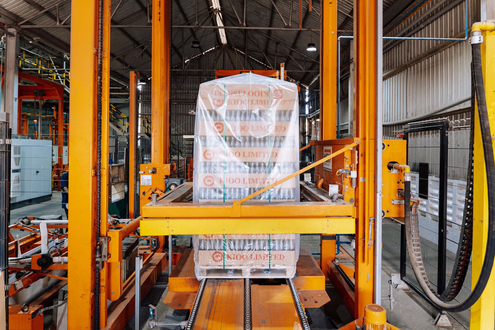 Shrink-wrapped, labelled product leaving an automated palletising line