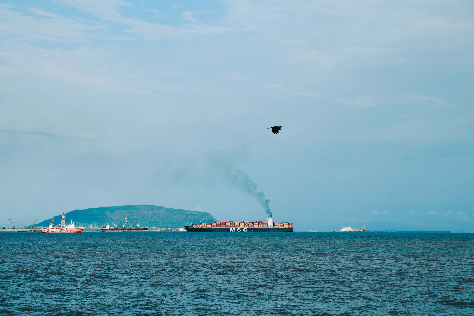 Container ship under way with an exhaust plume