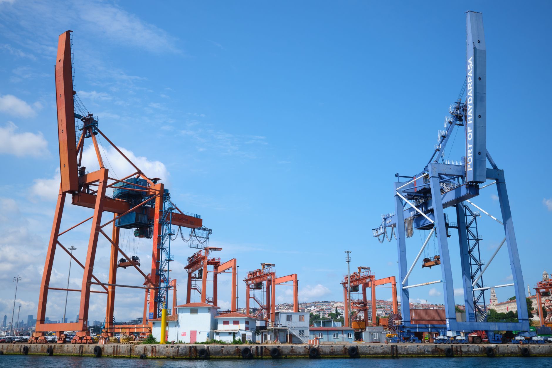 Cargo cranes at a port terminal where vehicle shipments clear customs