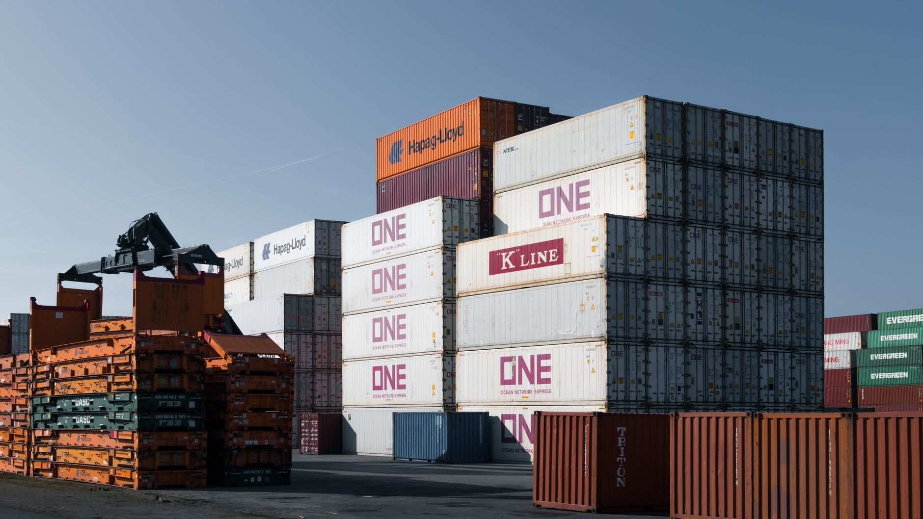 Stacked shipping containers in a port yard