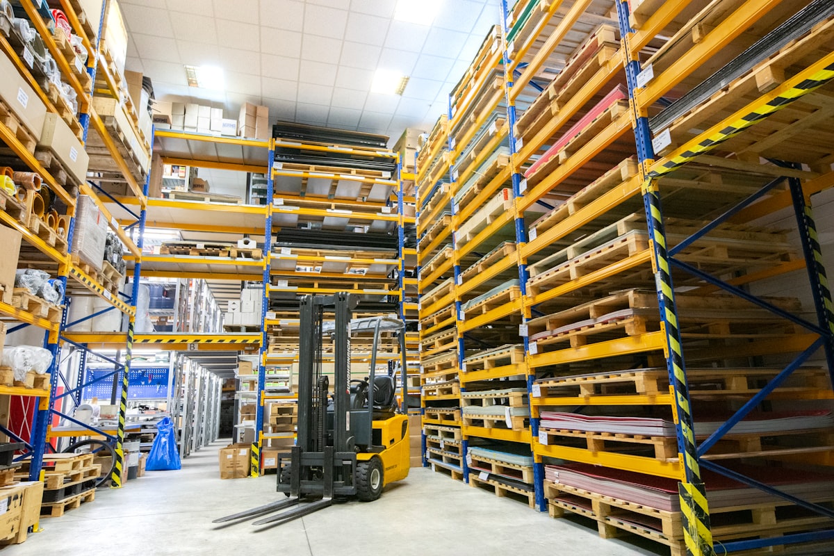 Forklift and pallet racks of wood products stored in a warehouse