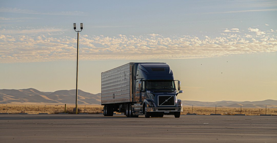 Semi-truck on a desert highway at sunset
