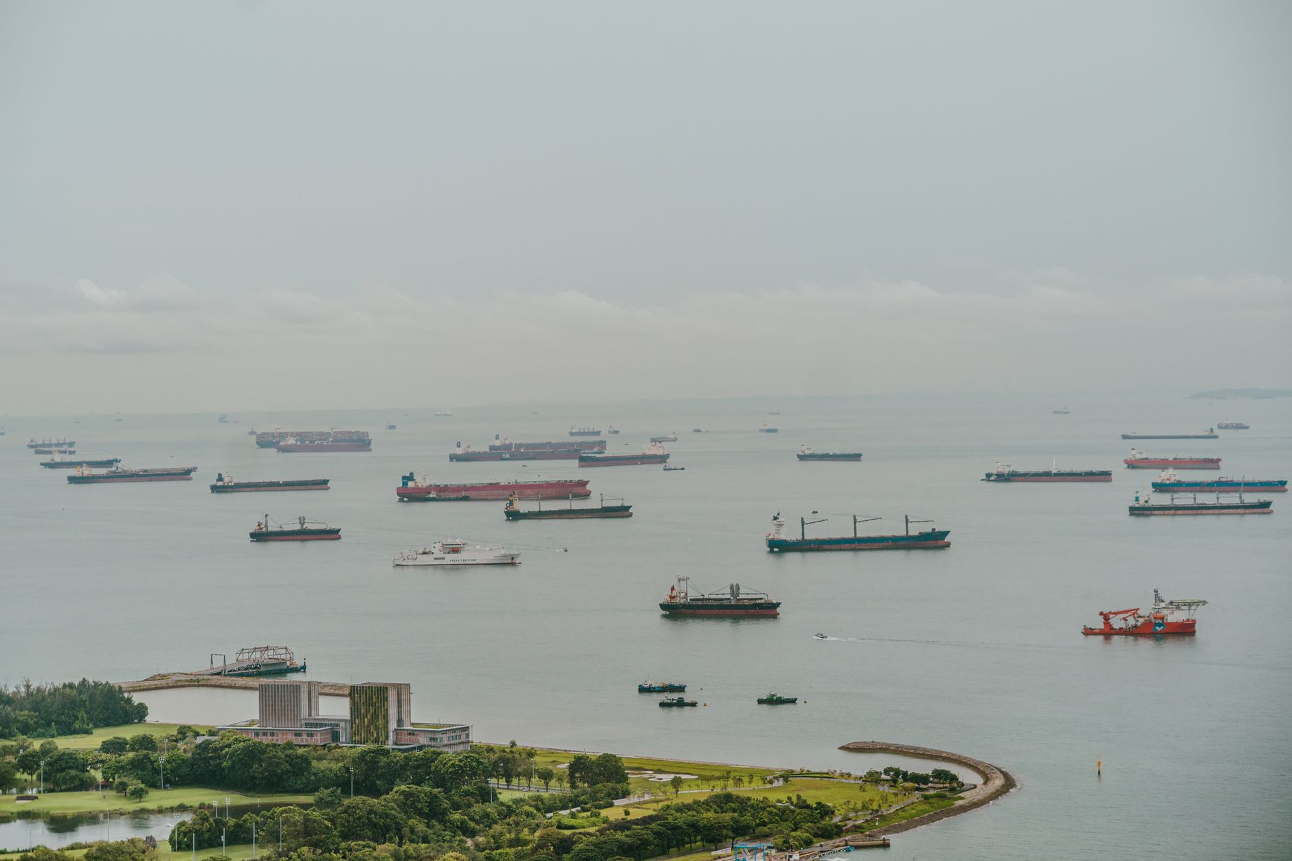 Cargo ships lying at anchor offshore while waiting for a berth or transit slot