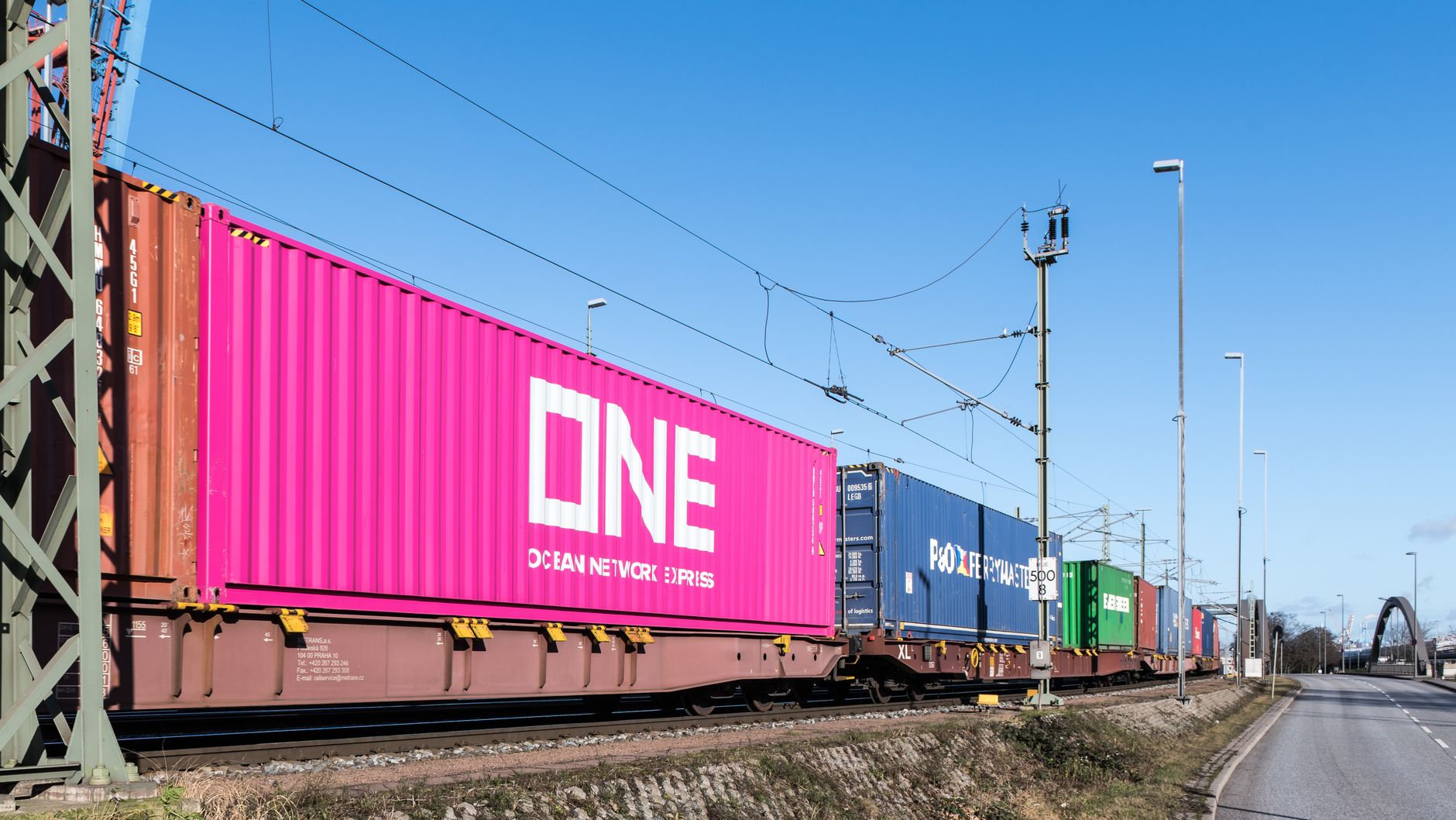 An intermodal freight train carrying shipping containers on an electrified line