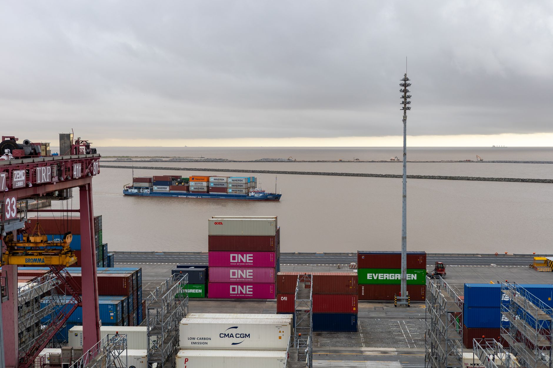 Containers stacked under a ship-to-shore crane at a Chinese export terminal