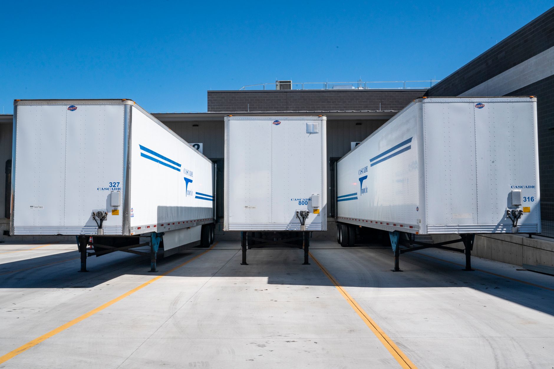 Dry-van trailers backed into loading-dock doors at a distribution centre
